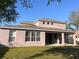Exterior view of home's backyard showing patio and upper windows at 13422 Exbury Ln, Windermere, FL 34786