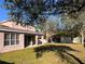 Large backyard featuring lush lawn and mature trees at 13422 Exbury Ln, Windermere, FL 34786