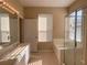 Bright bathroom with double vanity, glass-enclosed shower, soaking tub, and tile flooring at 13422 Exbury Ln, Windermere, FL 34786