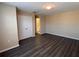 A simple bedroom with dark wood floors, double door closet, and ensuite bathroom at 13422 Exbury Ln, Windermere, FL 34786