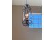 A decorative iron chandelier hangs near a window and illuminates the interior at 13422 Exbury Ln, Windermere, FL 34786