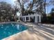 Community pool with shaded pergola sitting area near the water at 13422 Exbury Ln, Windermere, FL 34786