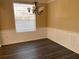 Charming dining room with modern chandelier, wainscoting, natural light, and sleek dark flooring at 13422 Exbury Ln, Windermere, FL 34786