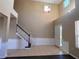 Bright foyer with high ceilings, decorative chandelier, staircase and elegant wainscoting detail at 13422 Exbury Ln, Windermere, FL 34786