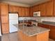 Well-lit kitchen features granite countertops and an island sink with stainless steel faucet at 13422 Exbury Ln, Windermere, FL 34786