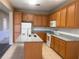 Well-equipped kitchen with granite countertops, an island, and wooden cabinetry for a functional space at 13422 Exbury Ln, Windermere, FL 34786