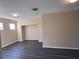 Spacious living room with a large opening and sleek, dark wood flooring at 13422 Exbury Ln, Windermere, FL 34786