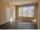 Bright living room with neutral walls and large windows, complemented by modern flooring at 13422 Exbury Ln, Windermere, FL 34786