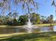 Scenic pond with a fountain, enhancing the natural beauty of the community at 13422 Exbury Ln, Windermere, FL 34786