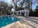 Community pool with shaded pergola-covered seating area at 13422 Exbury Ln, Windermere, FL 34786