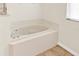 Bathroom featuring a tiled deck corner soaking tub with chrome faucet fixtures at 14740 Hartford Run Dr, Orlando, FL 32828