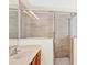 Bathroom with single sink, wood cabinets and a shower with glass doors at 14740 Hartford Run Dr, Orlando, FL 32828