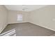 Spacious bedroom with gray carpet, a ceiling fan, and natural light from a window at 14740 Hartford Run Dr, Orlando, FL 32828