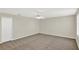 Neutral-toned carpeted bedroom with ceiling fan and closet at 14740 Hartford Run Dr, Orlando, FL 32828