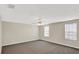 Bedroom featuring neutral walls, carpeted floors, a ceiling fan, and windows at 14740 Hartford Run Dr, Orlando, FL 32828
