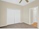 Bedroom featuring carpet, a ceiling fan, and closet with bi-fold doors at 14740 Hartford Run Dr, Orlando, FL 32828