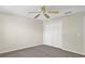 Bedroom with carpet, ceiling fan, and double door closet at 14740 Hartford Run Dr, Orlando, FL 32828