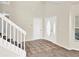 Bright entryway with tile flooring, white trim, and a staircase leading to the upper level at 14740 Hartford Run Dr, Orlando, FL 32828