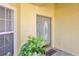 Close-up of a front door with decorative glass and a small, welcoming potted plant at 14740 Hartford Run Dr, Orlando, FL 32828