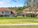 Two golfers play a round of golf on a sunny day, with beautiful homes in the background at 14740 Hartford Run Dr, Orlando, FL 32828