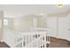 Upstairs hallway with neutral walls, white railing, and carpeted floors at 14740 Hartford Run Dr, Orlando, FL 32828