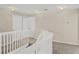 Upstairs hallway with neutral walls, white railing, carpeted floors, and lighting at 14740 Hartford Run Dr, Orlando, FL 32828