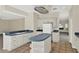 Eat-in kitchen with white cabinets, an island, and plenty of countertop space for cooking and storage at 14740 Hartford Run Dr, Orlando, FL 32828