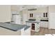 Spacious eat-in kitchen with island, tile floors, white cabinets, and breakfast bar at 14740 Hartford Run Dr, Orlando, FL 32828