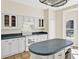 Bright kitchen with white appliances, tile floors, and ample cabinet space at 14740 Hartford Run Dr, Orlando, FL 32828