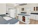Updated kitchen with tile flooring, island, white appliances, and ample cabinet space at 14740 Hartford Run Dr, Orlando, FL 32828