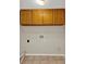 Laundry room featuring tile flooring and overhead cabinets at 14740 Hartford Run Dr, Orlando, FL 32828