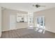 Bright open-concept living room with carpet and tile, and kitchen access at 14740 Hartford Run Dr, Orlando, FL 32828