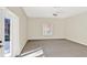 Spacious living room with carpet, neutral walls, ceiling fan and door to the outside patio at 14740 Hartford Run Dr, Orlando, FL 32828