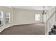 Spacious living room features neutral carpet, a modern light fixture, and abundant natural light at 14740 Hartford Run Dr, Orlando, FL 32828