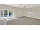 Bright and airy living room with plush carpeting and serene pool views at 14740 Hartford Run Dr, Orlando, FL 32828