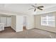 Carpeted main bedroom with ceiling fan, window with blinds, and en suite bathroom at 14740 Hartford Run Dr, Orlando, FL 32828