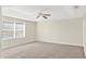 Carpeted main bedroom with tray ceiling, ceiling fan, and window with blinds at 14740 Hartford Run Dr, Orlando, FL 32828
