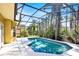 Screened pool with blue tile trim and view of the backyard at 14740 Hartford Run Dr, Orlando, FL 32828