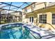 Screened-in pool features a tile trim, steps, and view of the home's exterior at 14740 Hartford Run Dr, Orlando, FL 32828