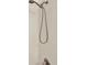 Shower with tiled wall and adjustable shower head on a sliding bar at 14740 Hartford Run Dr, Orlando, FL 32828