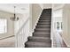 Carpeted staircase with white railings leading to the upper level, open to the living area at 14740 Hartford Run Dr, Orlando, FL 32828