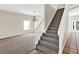 Carpeted staircase with white railings leading to the upper level, open to the living area at 14740 Hartford Run Dr, Orlando, FL 32828