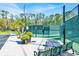 Exterior view of the community tennis court with green fencing and landscaping at 14740 Hartford Run Dr, Orlando, FL 32828