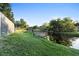 Backyard featuring a boat dock, canal access and mature landscaping at 1475 Kettledrum Trl, Deltona, FL 32725
