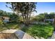 Backyard featuring trees, green grass, and shed structure at 1475 Kettledrum Trl, Deltona, FL 32725