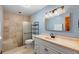 Bathroom featuring a tiled shower, modern vanity, and good lighting at 1475 Kettledrum Trl, Deltona, FL 32725