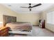 Bedroom with neutral walls, a ceiling fan, and a large window at 1475 Kettledrum Trl, Deltona, FL 32725