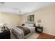 Bright bedroom featuring neutral walls, hardwood floors, and a window overlooking the greenery at 1475 Kettledrum Trl, Deltona, FL 32725