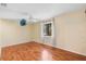 A bright bedroom with light walls, wood floors, a ceiling fan, and a window at 1475 Kettledrum Trl, Deltona, FL 32725