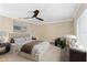 A stylish bedroom featuring neutral tones, a ceiling fan, and lots of natural light at 1475 Kettledrum Trl, Deltona, FL 32725